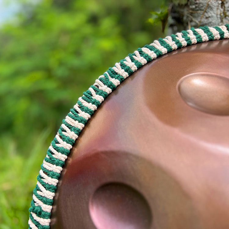 LIDAH Handpan Rope In green Color Aroun a Handpan Against a Tree