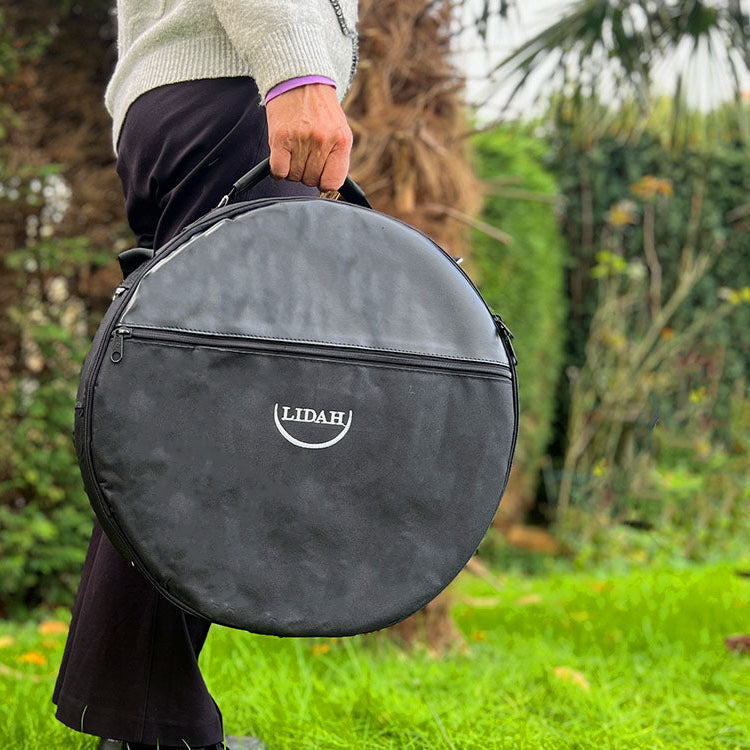 LIDAH Shamanic Drum Bag Being Held in a hand outside by a woman in nature