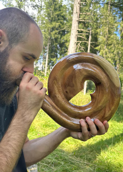 Spiral Didgeridoo bespeeld door een man buiten