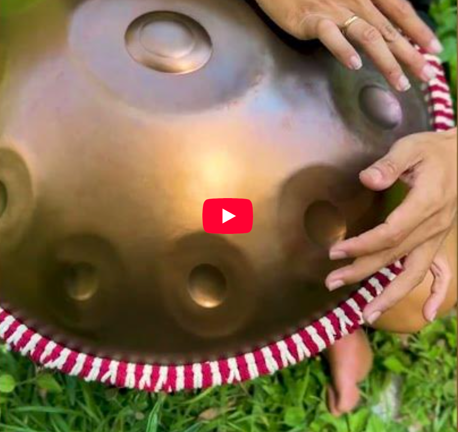 Handpan being played with Red handpan rope around it
