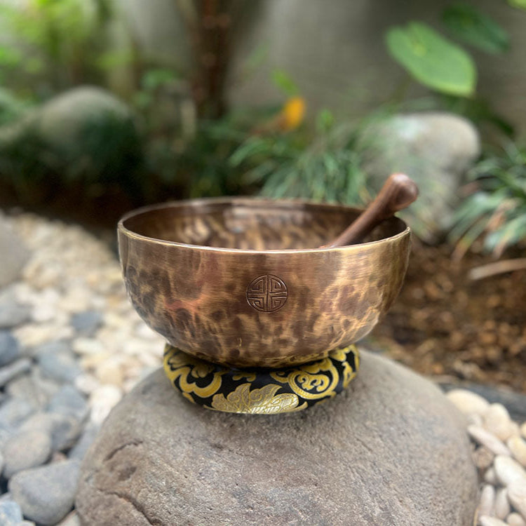 Handcrafted Full Moon Singing Bowl shining under warm light