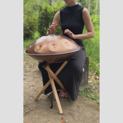 Handpan being played on a handpan stand
